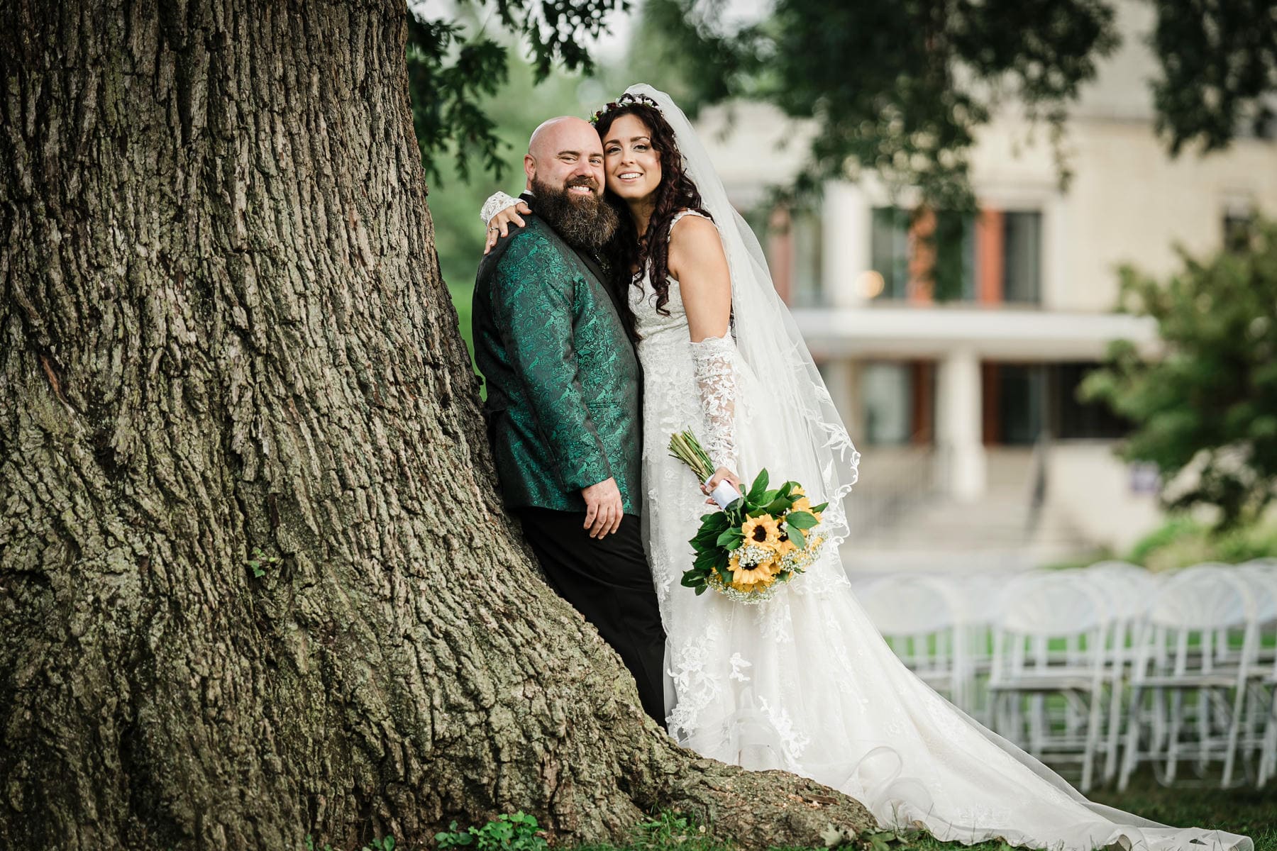 Desiree and Ryan pose beside the oak tree at Collingswood Grand Ballroom.