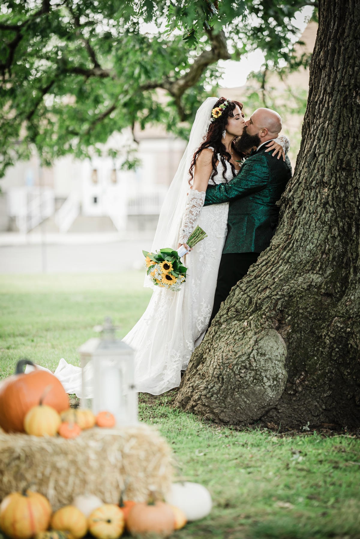 Couple beside an oak tree and pumpkins at a fall Collingswood Grand Ballroom wedding