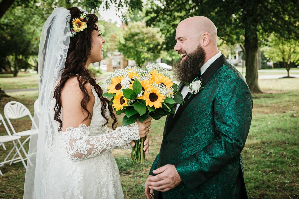 Bride holding a sunflower bouquet beside her groom at Collingswood Grand Ballroom