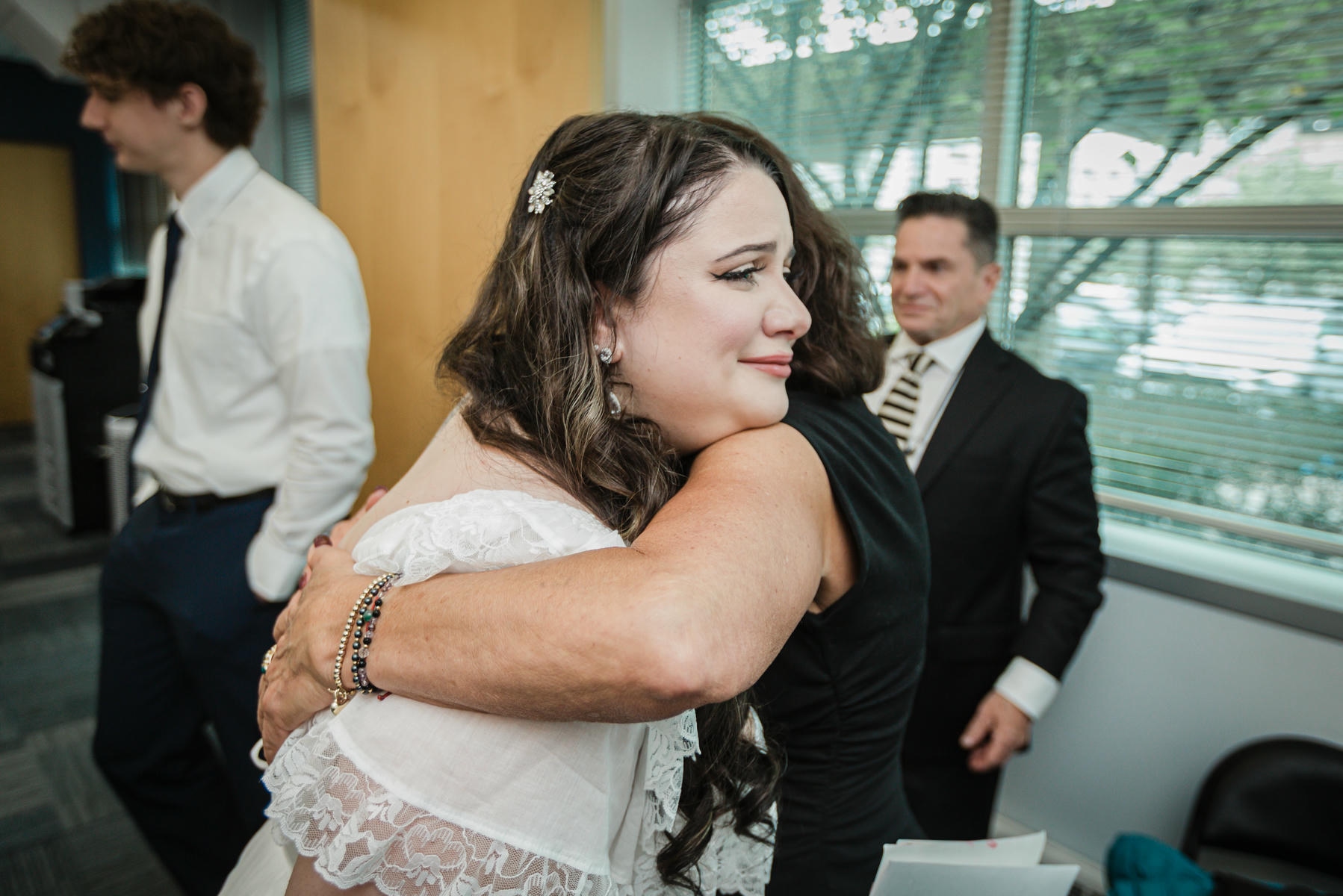 Family member hugs a newlywed after the courthouse ceremony in Hackensack, NJ
