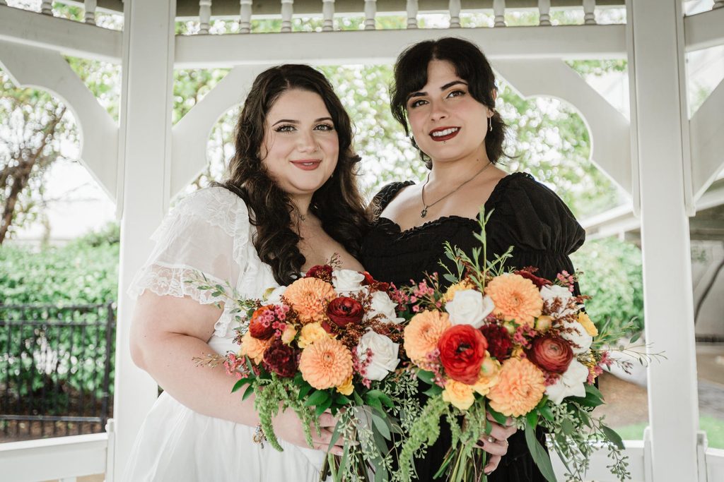 Couple with bouquets shares a close portrait in a gazebo after their Hackensack NJ courthouse wedding
