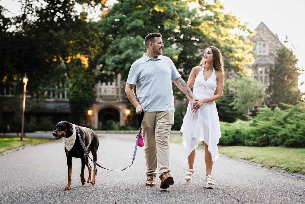 Couple walking with their dog during a New Jersey engagement photo session