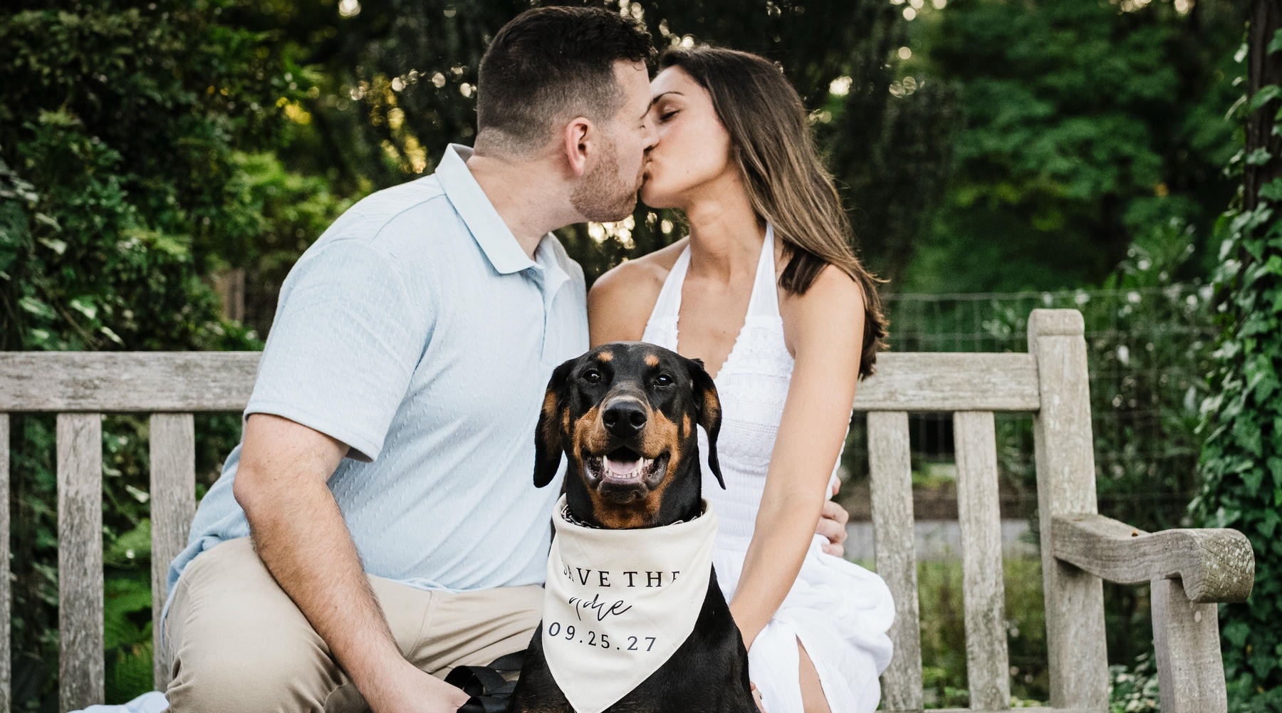 Jonathan and Emma kissing with their dog during their Skylands Manor engagement session