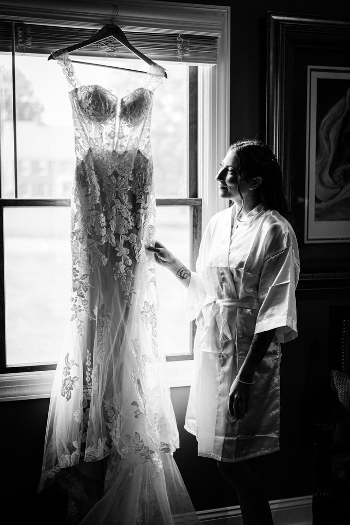 Wedding dress hanging beside a window at a childhood home in Franklin Township