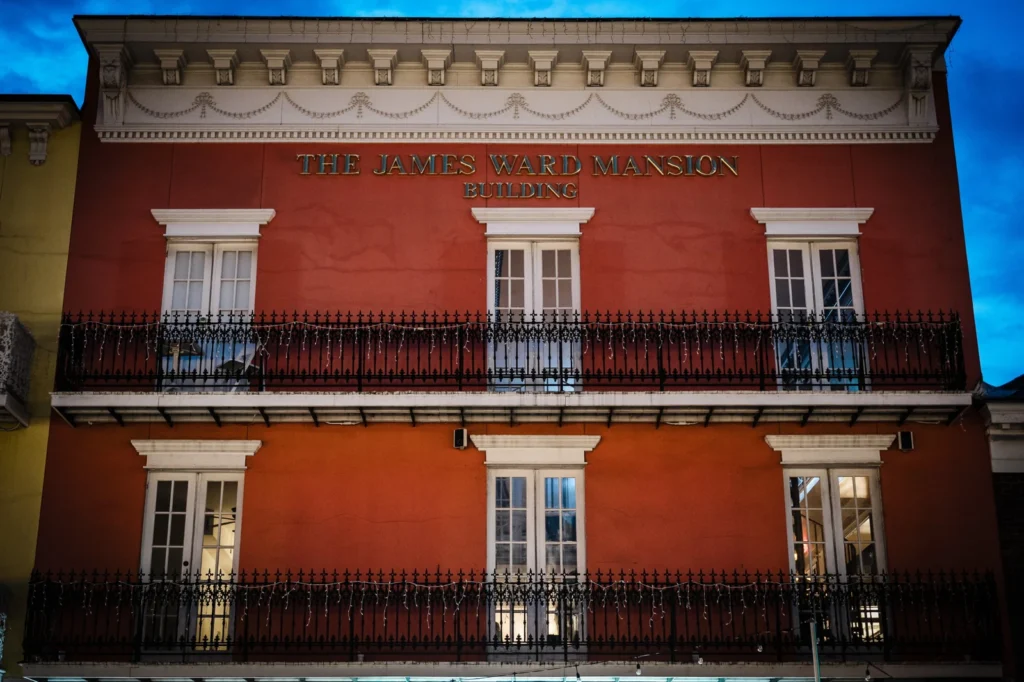Red facade and iron balconies of the James Ward Mansion in Westfield NJ at dusk
