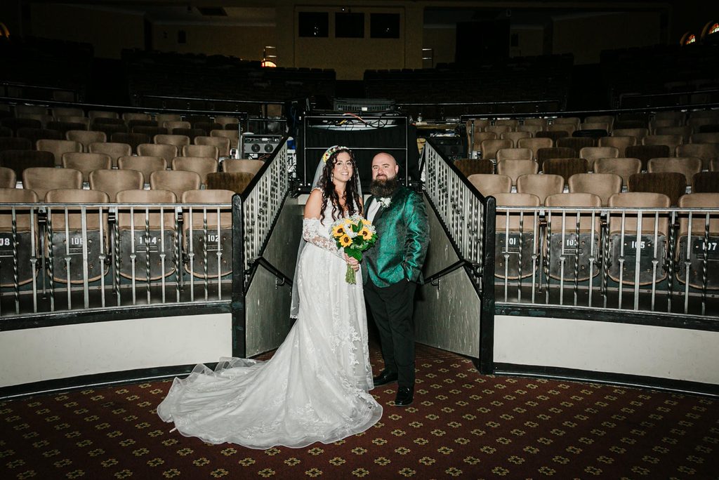 Wide view of the couple inside the Scottish Rite Theater at Collingswood Grand Ballroom