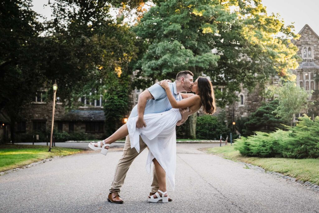 Jonathan and Emma kissing during a dip at Skylands Manor engagement session in New Jersey
