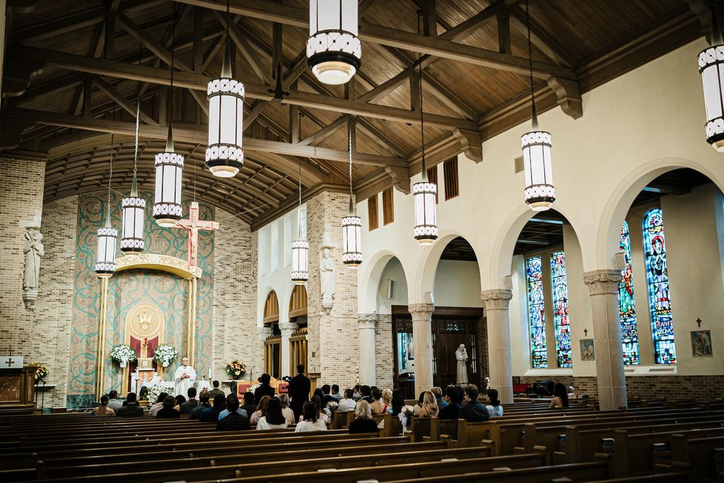 Wedding guests seated in the nave during a ceremony at St. Gregory the Great Church