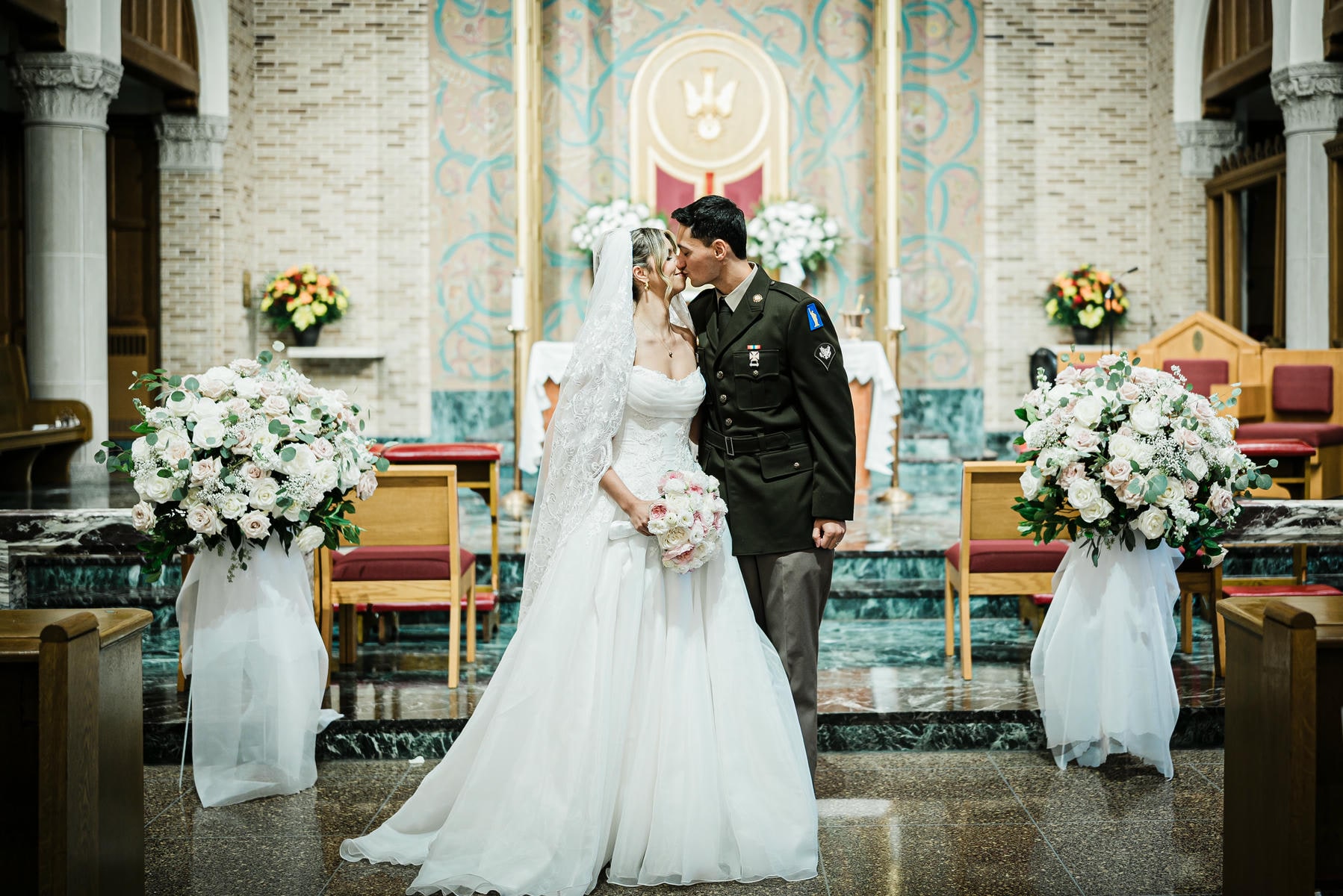 Bride and groom kissing at the altar of St. Gregory the Great Church in Harrison NY